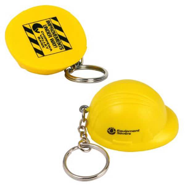 A yellow keyring featuring a helmet-shaped stress reliever with a keychain attachment. It has a logo on one side. Keyring with Helmet Stress Reliever - Image 1