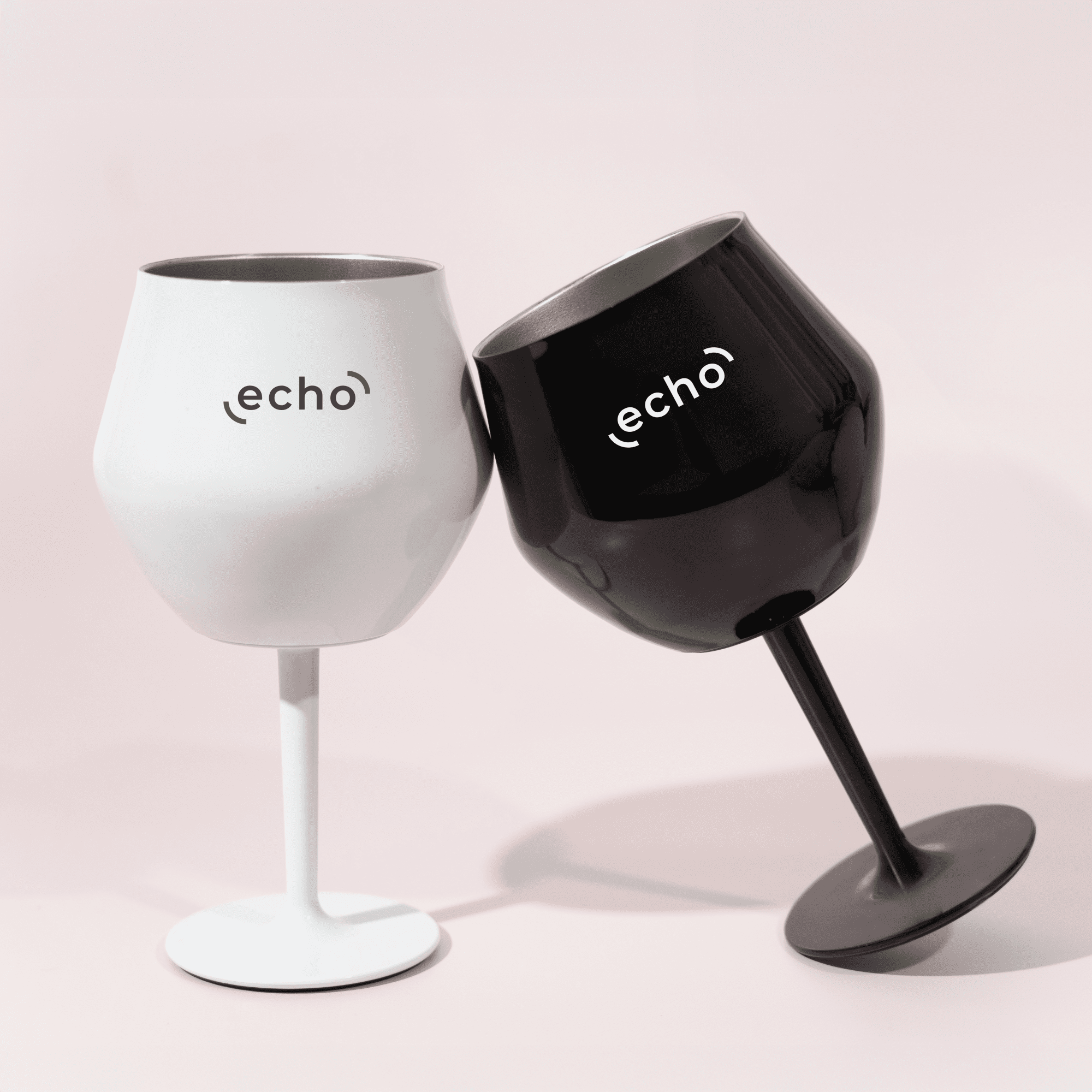 Two detachable wine glasses in black and white, featuring a logo on each, positioned together. Shiraz Detachable Wine Glass - Image 1