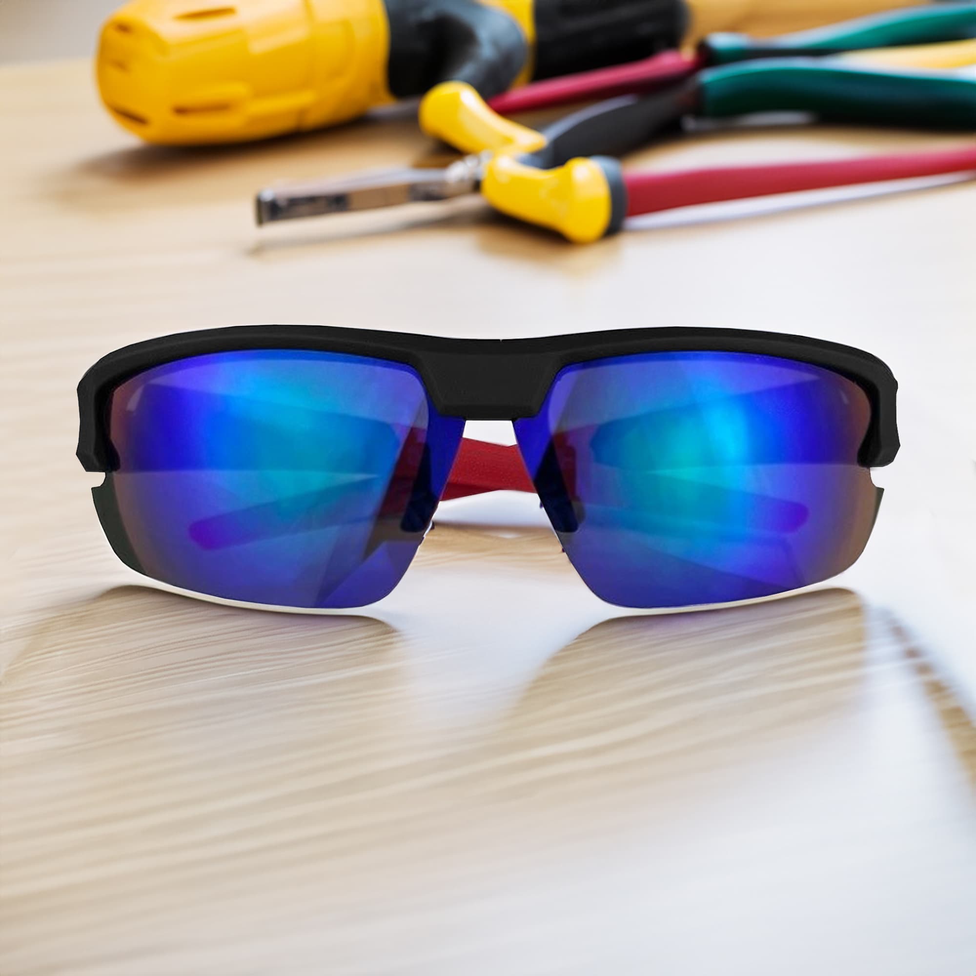 Sporty black sunglasses with blue reflective lenses, positioned on a wooden surface near tools. Features a logo. Logan Shield Sunglasses - Image 1