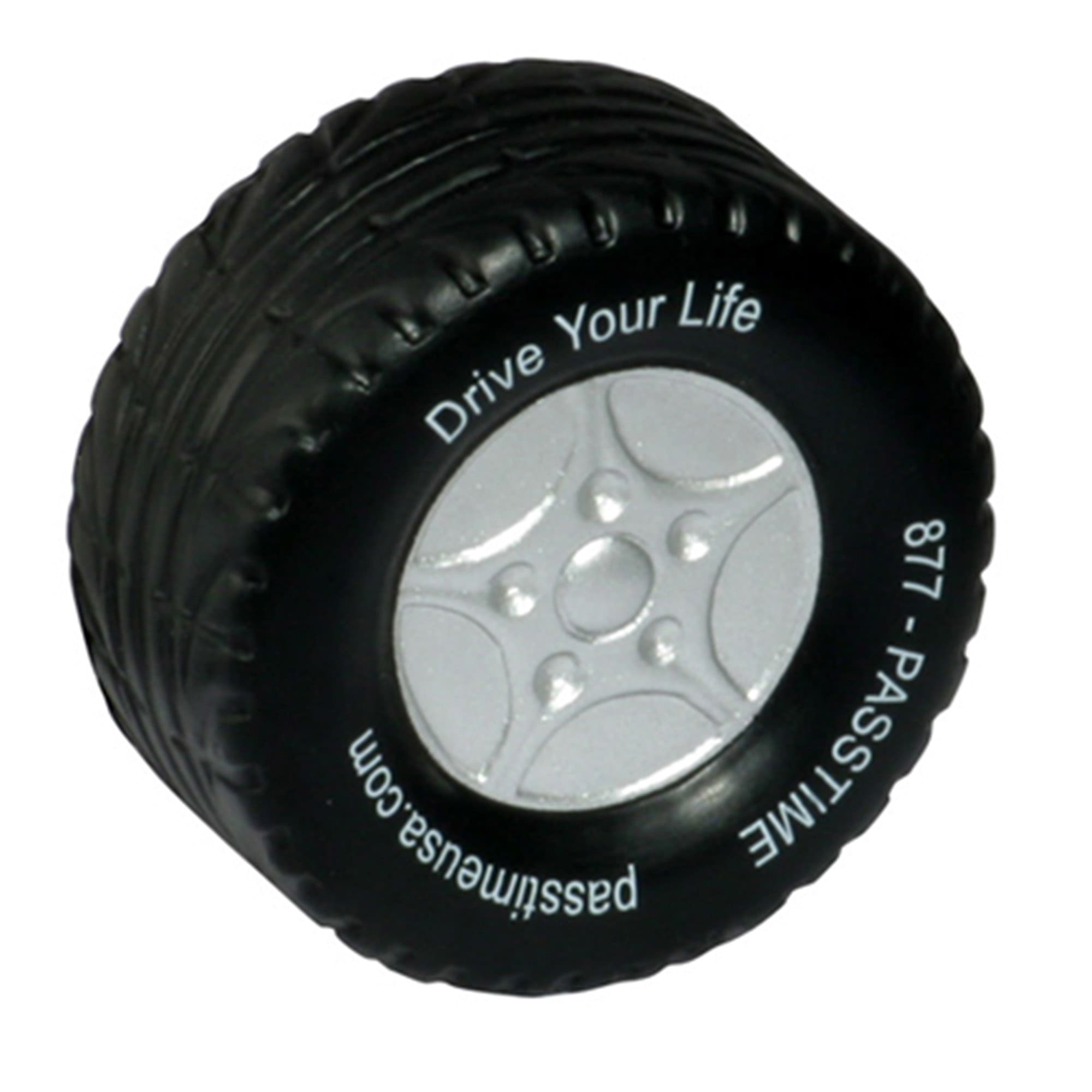 A black stress reliever shaped like a tyre with silver detailing and a logo on the side. Stress Tyre - Image 1