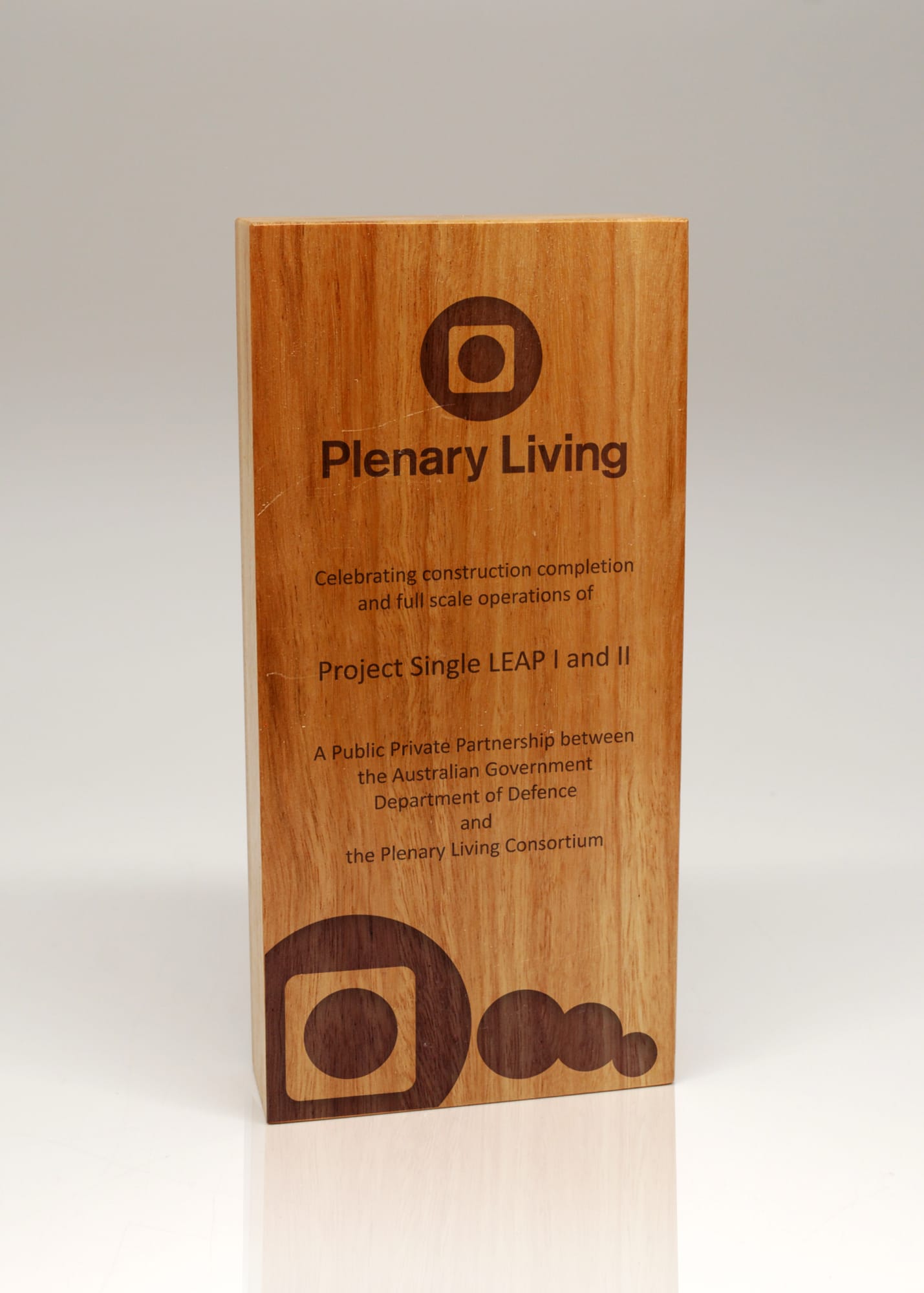 A wooden trophy plaque featuring a natural finish, engraved text, and a logo. Australian Select Grade Blackbutt Quadril Trophy - Image 1