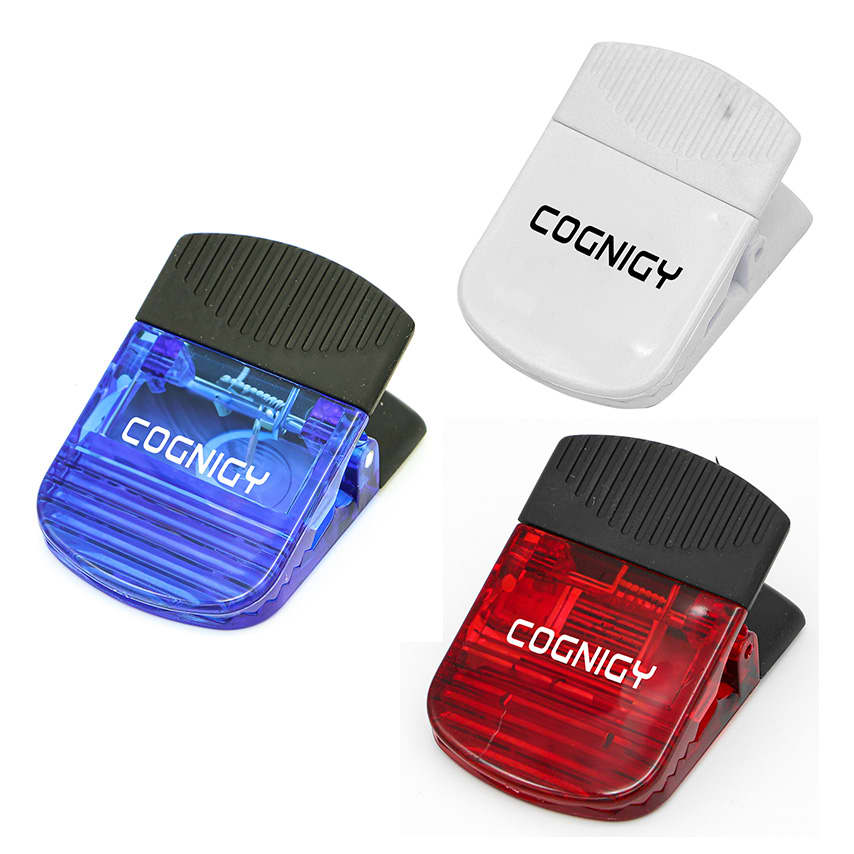 Three plastic magnetic clips in blue, red, and white, featuring a clip design and a logo on each. Wide Magnetic Croc Clip - Image 1
