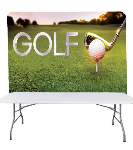 A stretch fabric table top banner stand featuring a golf theme with a large golf tee, ball, and club against a green background. Stretch Fabric Table Top Banner Stand (8ft) - Image 1