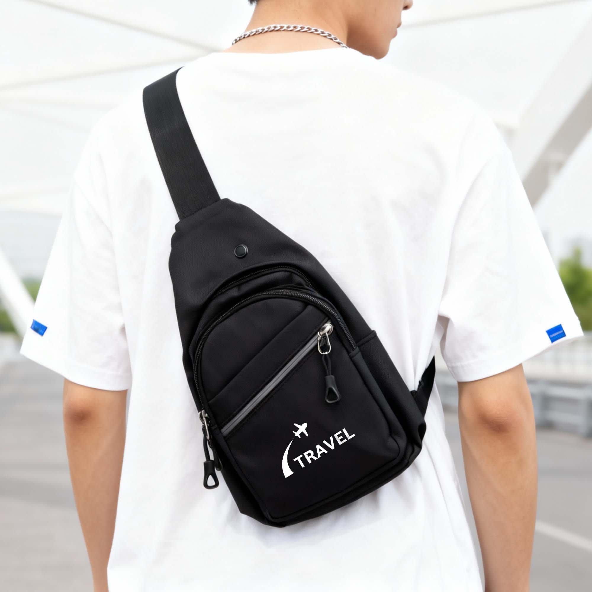 A black sling bag with a logo, featuring multiple zippered compartments, worn across the back of a person. Traveller Sling Bag - Image 1