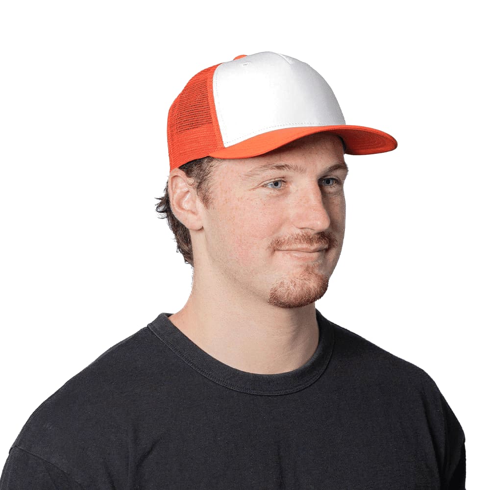 A Turbine Trucker Cap in white and orange, featuring a logo, worn by a man. Trekk Turbine Trucker Cap - Image 1