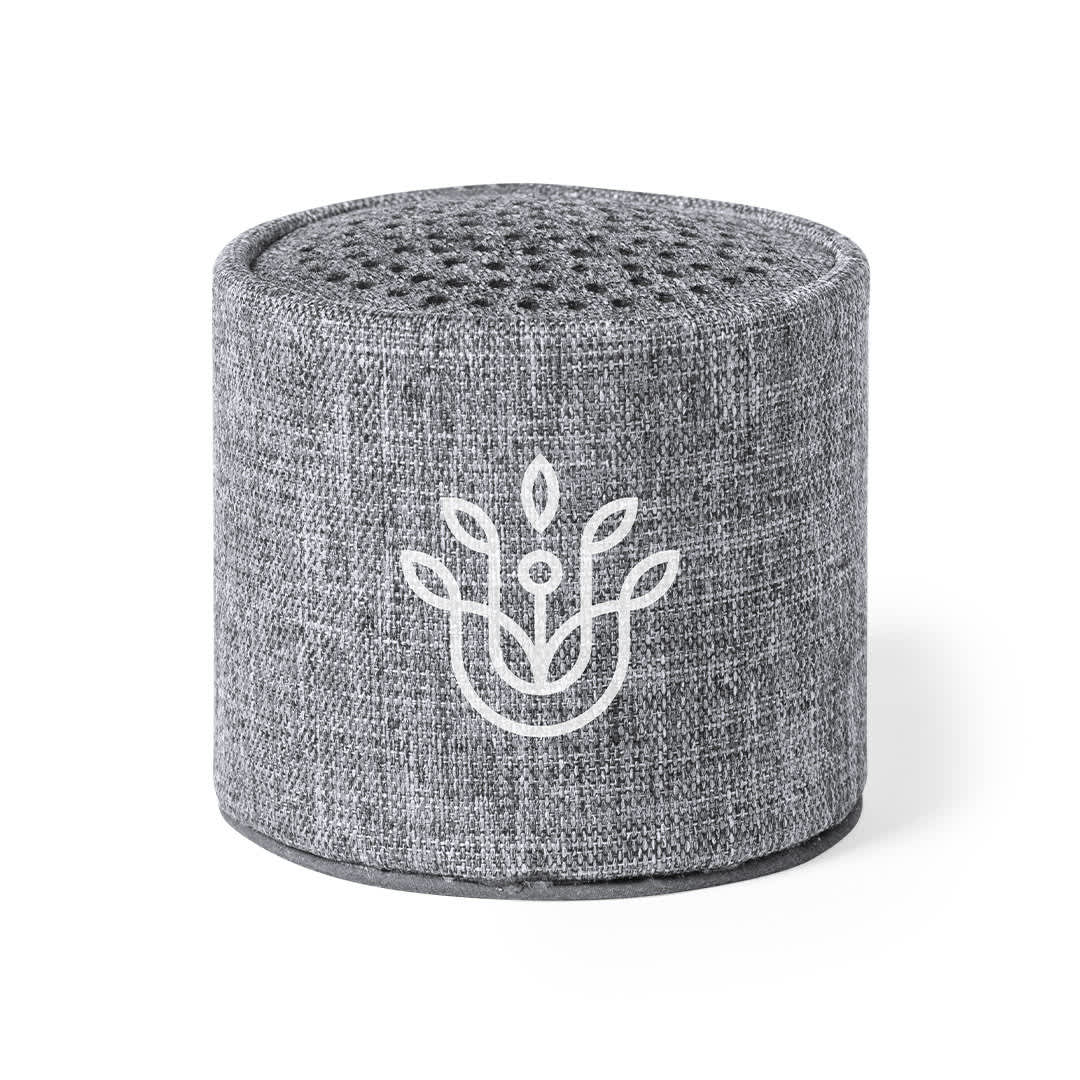 A grey portable speaker with a textured fabric finish and a logo on the front. Donny Speaker - Image 1