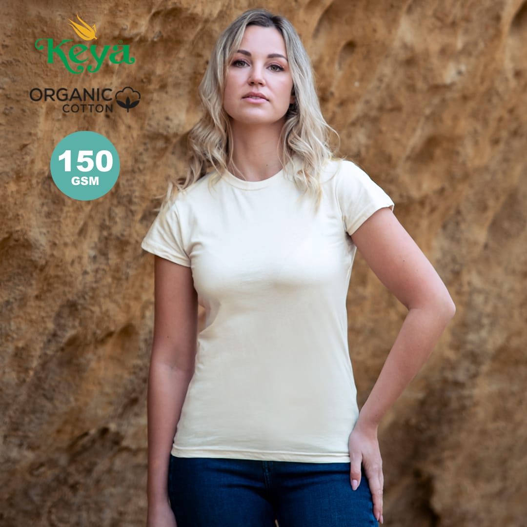 A woman poses in a cream organic cotton T-shirt against a textured backdrop. The shirt has a logo. Organic WM Women T-Shirt "keya" - Image 1