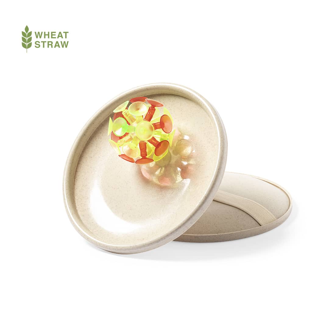 A beige game disc with a colourful, textured ball design on top. The product is made from wheat straw and includes branding. Croak Game - Image 1