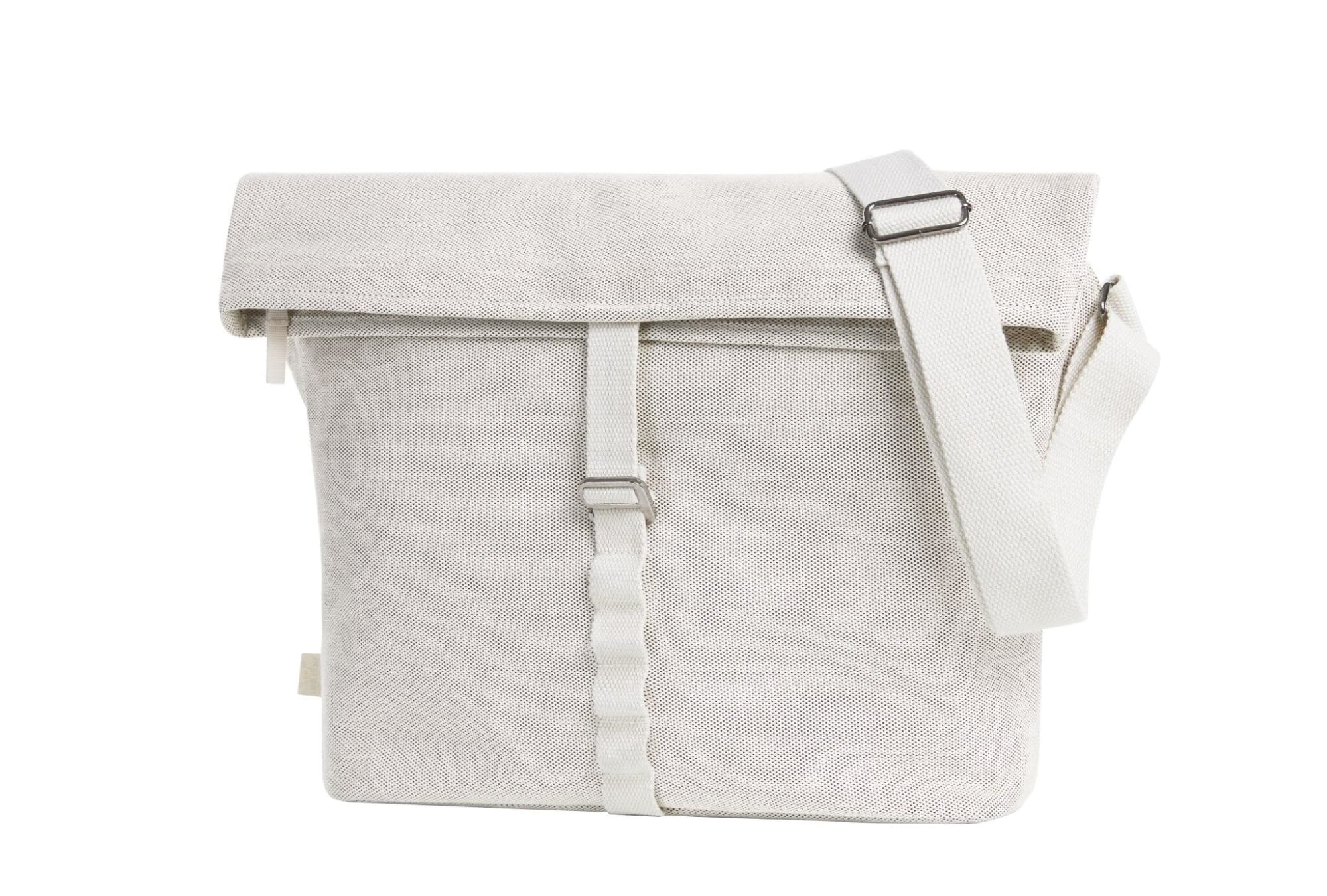 A light grey satchel bag with a strap, featuring a roll-top closure and a distinctive buckle. Loom Shoulder Bag - Image 1