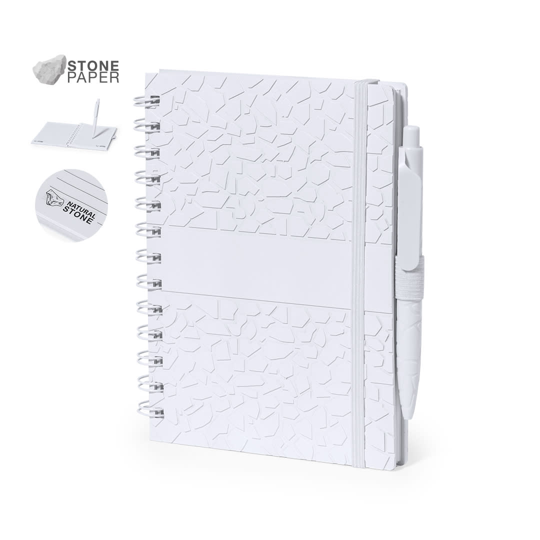 A white notebook with a textured cover, spiral binding, and a matching pen. It has a logo on the cover. Amber Notebook - Image 1