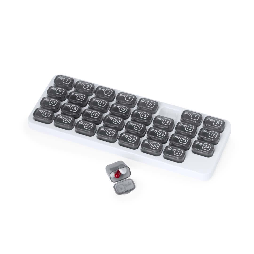 A pillbox with a white base and grey compartments, featuring numbered labels for organisation. Stexio Pillbox - Image 1