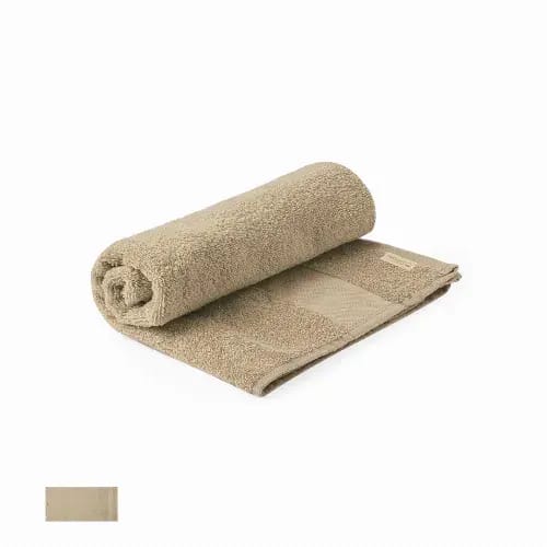 A rolled towel in a sandy beige colour, featuring a textured surface and a smooth section. It has a logo on one side. Canoria - Image 1