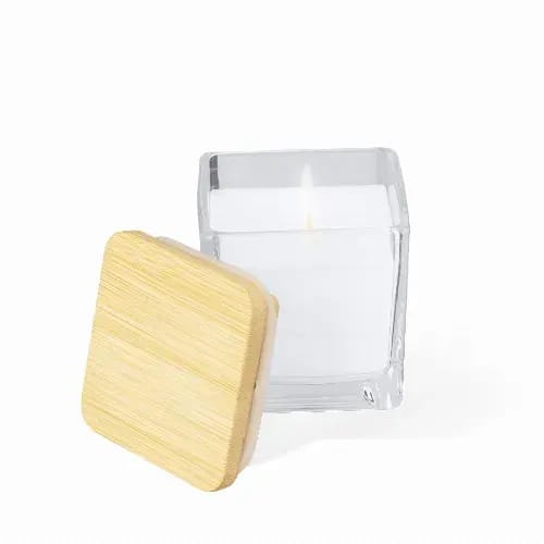 A candle in a clear glass container with a wooden lid. The candle is white and the lid is light wood. Safron - Image 1
