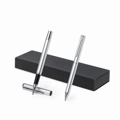 A set of silver pens displayed atop a black gift box. The pens have a sleek design and feature a branding logo. Darma - Image 1