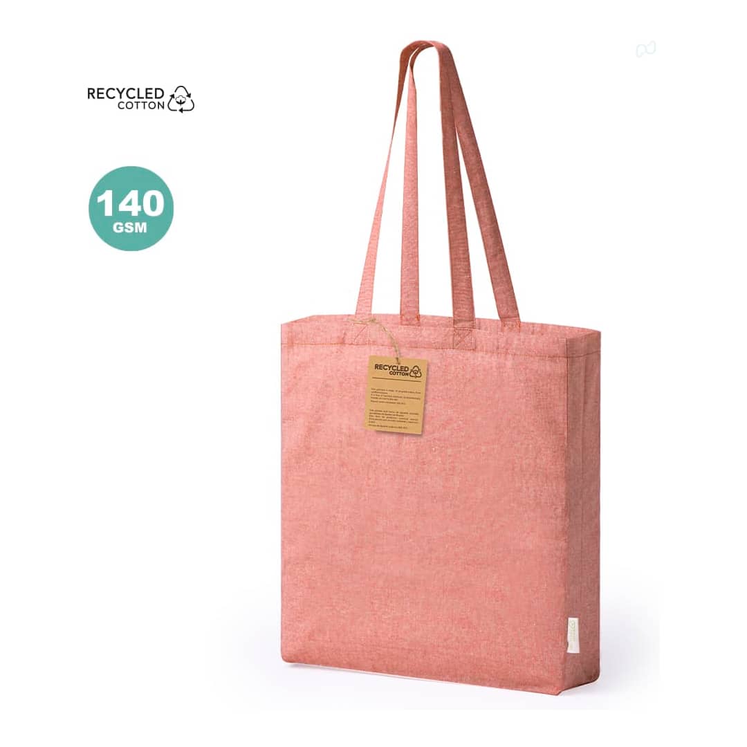 A tote bag in a soft pink hue made from recycled cotton, featuring two sturdy handles and a tag. Bestla Bag - Image 1