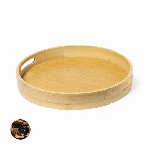 A round bamboo tray featuring two handles and a smooth, natural finish. The tray is light in colour and minimalist in design. Meltem - Image 1