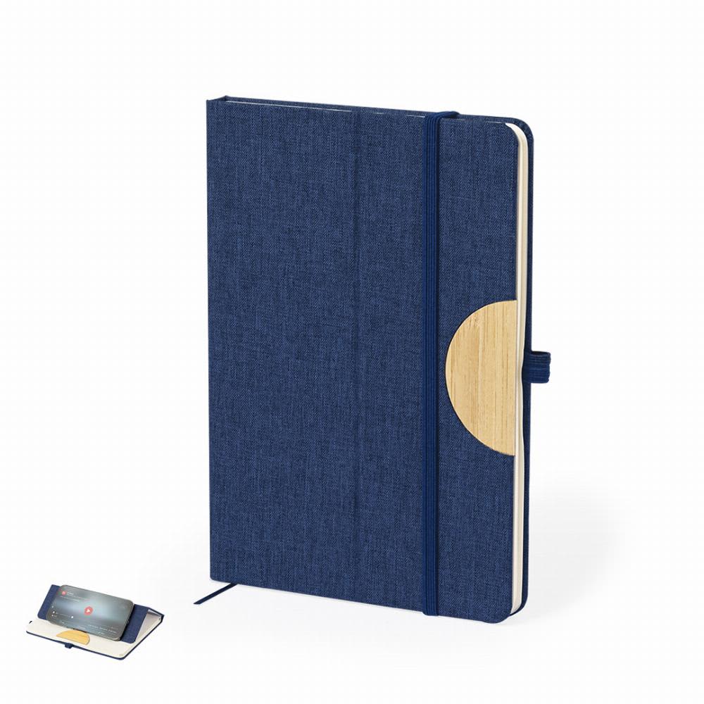 A navy blue notebook with a fabric cover and a circular wooden accent, secured with an elastic band. Jibs - Image 1