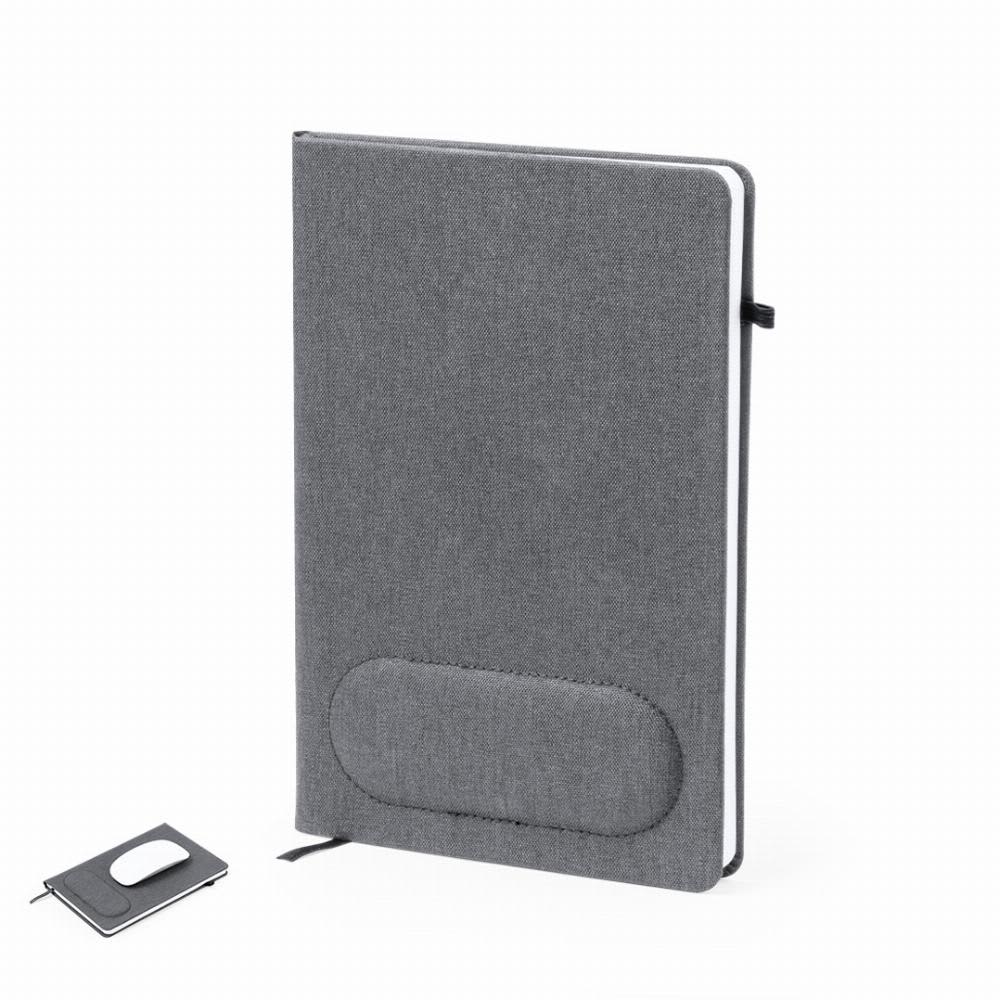 A grey notebook with a textured cover and a matching grey pen, featuring a branding logo. Staiger - Image 1