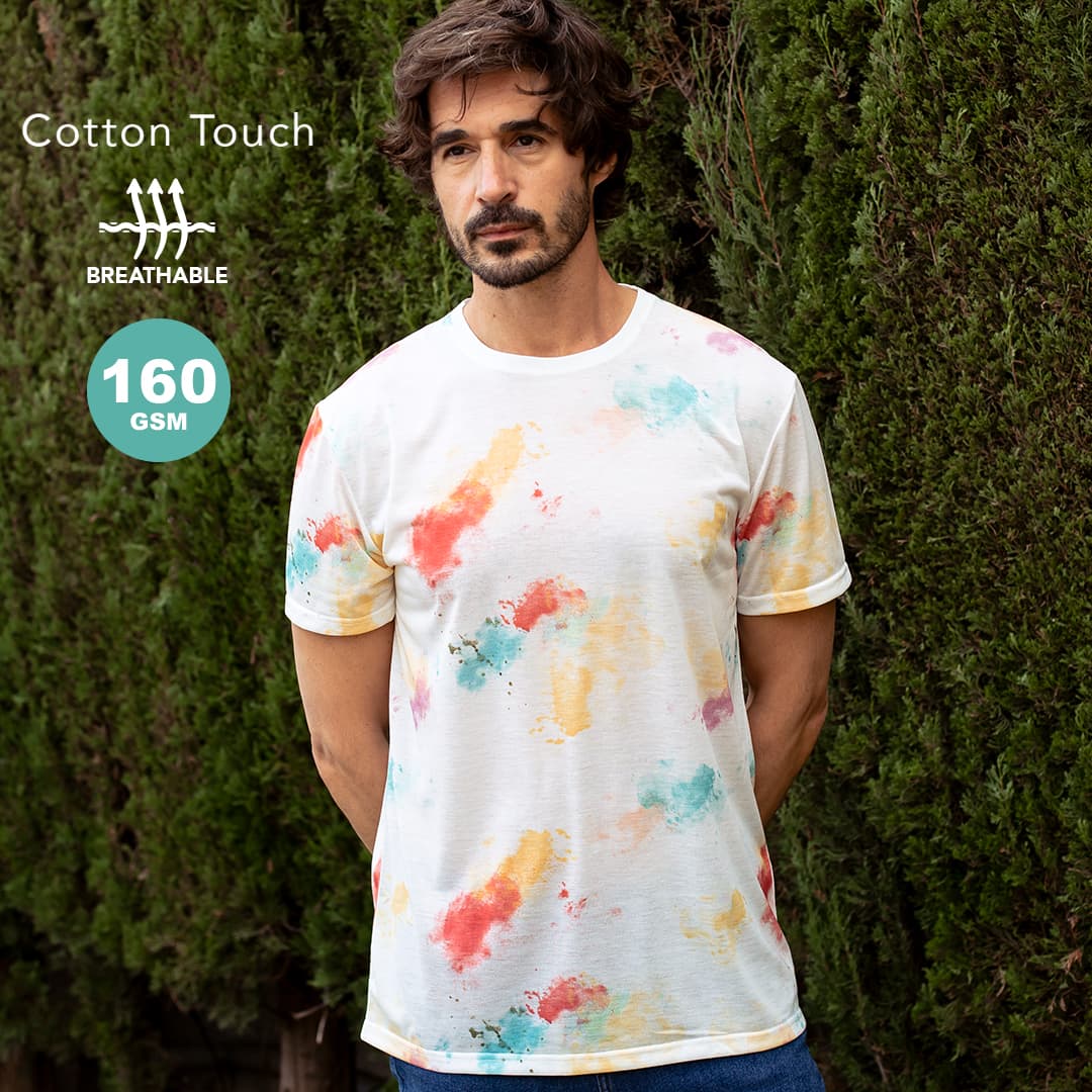 A man wearing a short-sleeved white T-shirt with a multicoloured splash pattern, standing against greenery. Hearvin Adult T-Shirt - Image 1