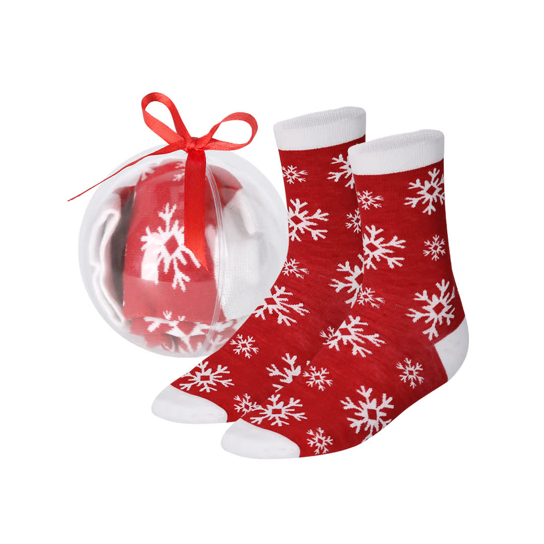 Red socks featuring a snowflake pattern, packaged in a clear sphere with a red ribbon. Scrubit Sock - Image 1
