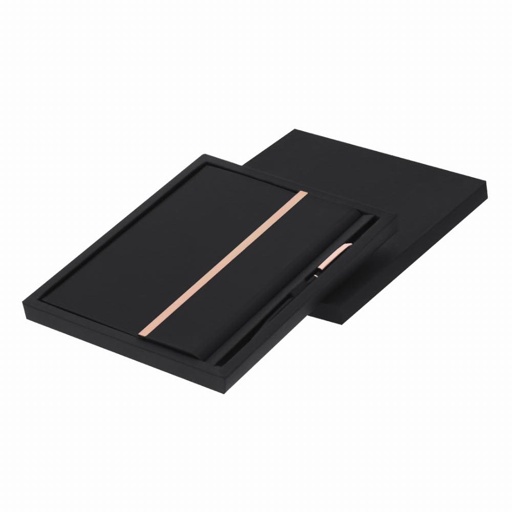 A black notebook and pen set presented in a sleek black box, featuring a rose gold accent on the notebook. Kassex - Image 1