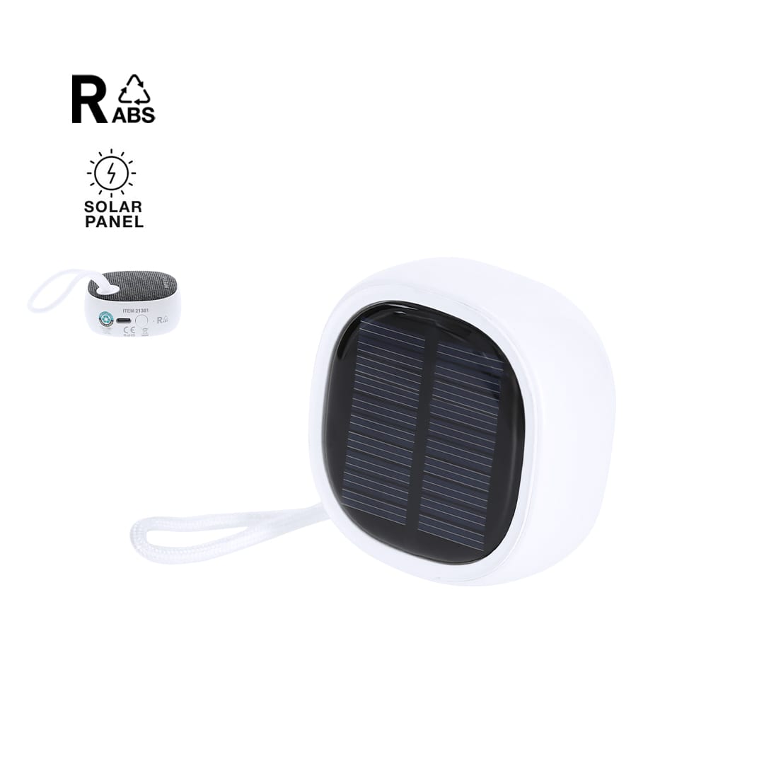 A compact white speaker with a solar panel on top and a looped strap for portability. It features a logo. Kompec RCS Speaker - Image 1