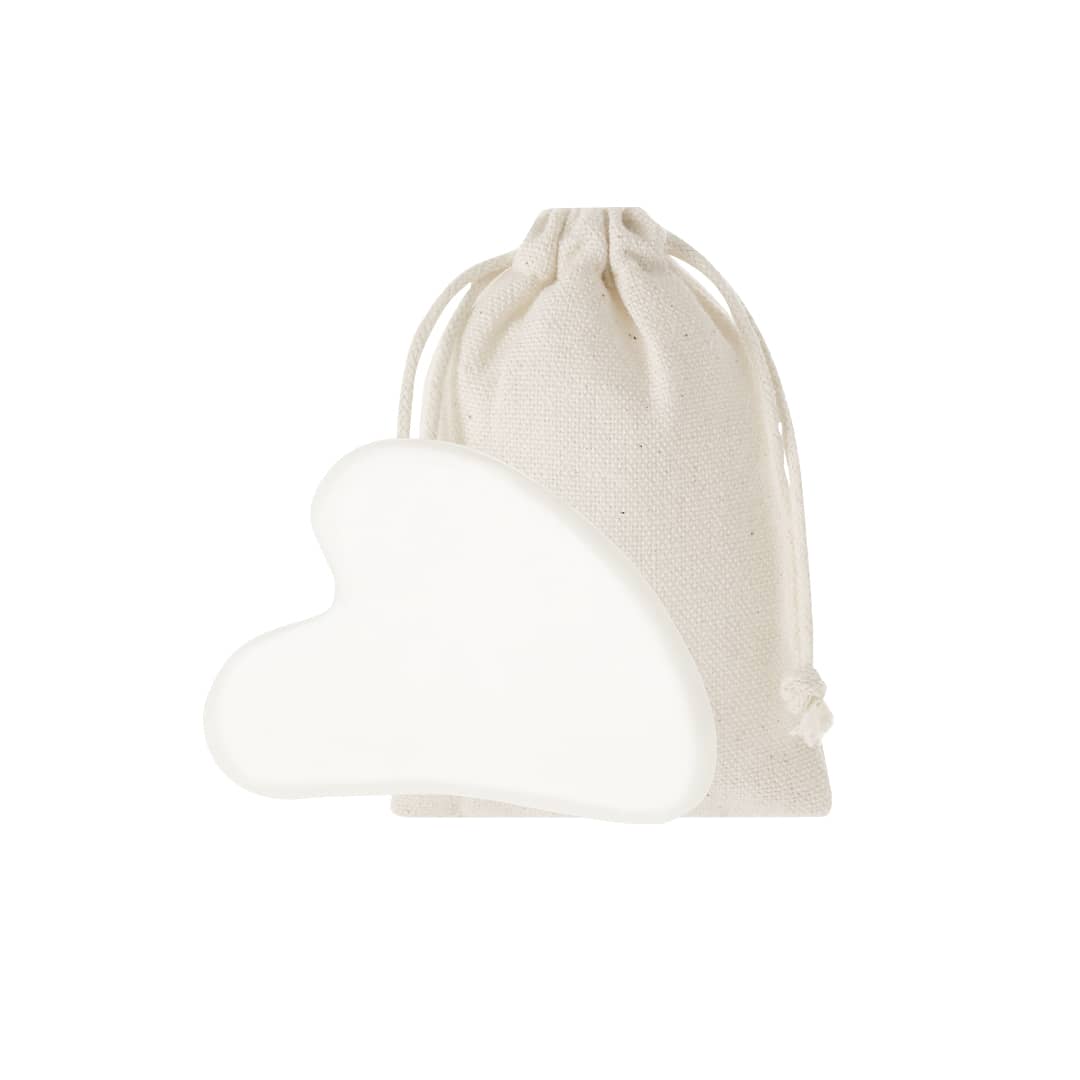 A white heart-shaped Kunkor Face Massager beside a natural fabric pouch. Kunkor Face Massager - Image 1