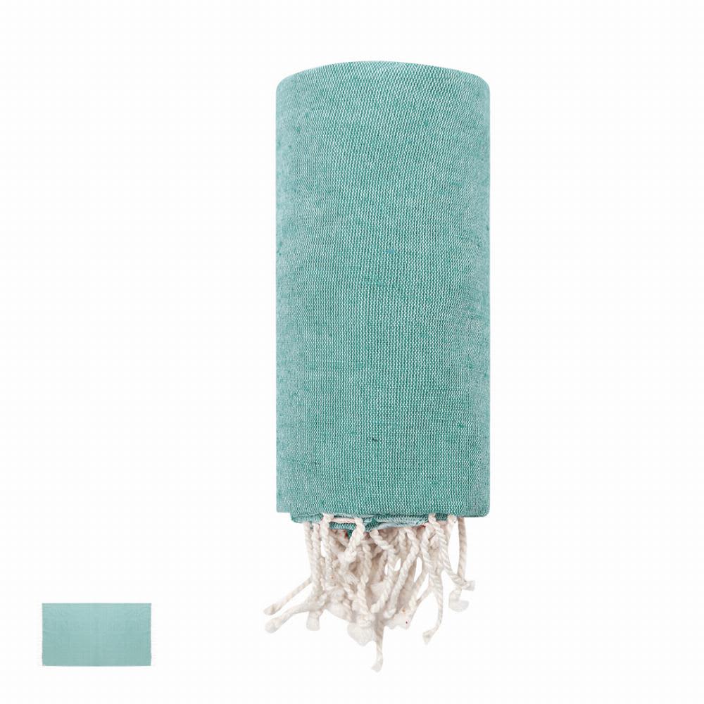 A teal towel with tassels, neatly rolled up, featuring a plain design. A smaller folded towel is visible beside it. Dikky - Image 1