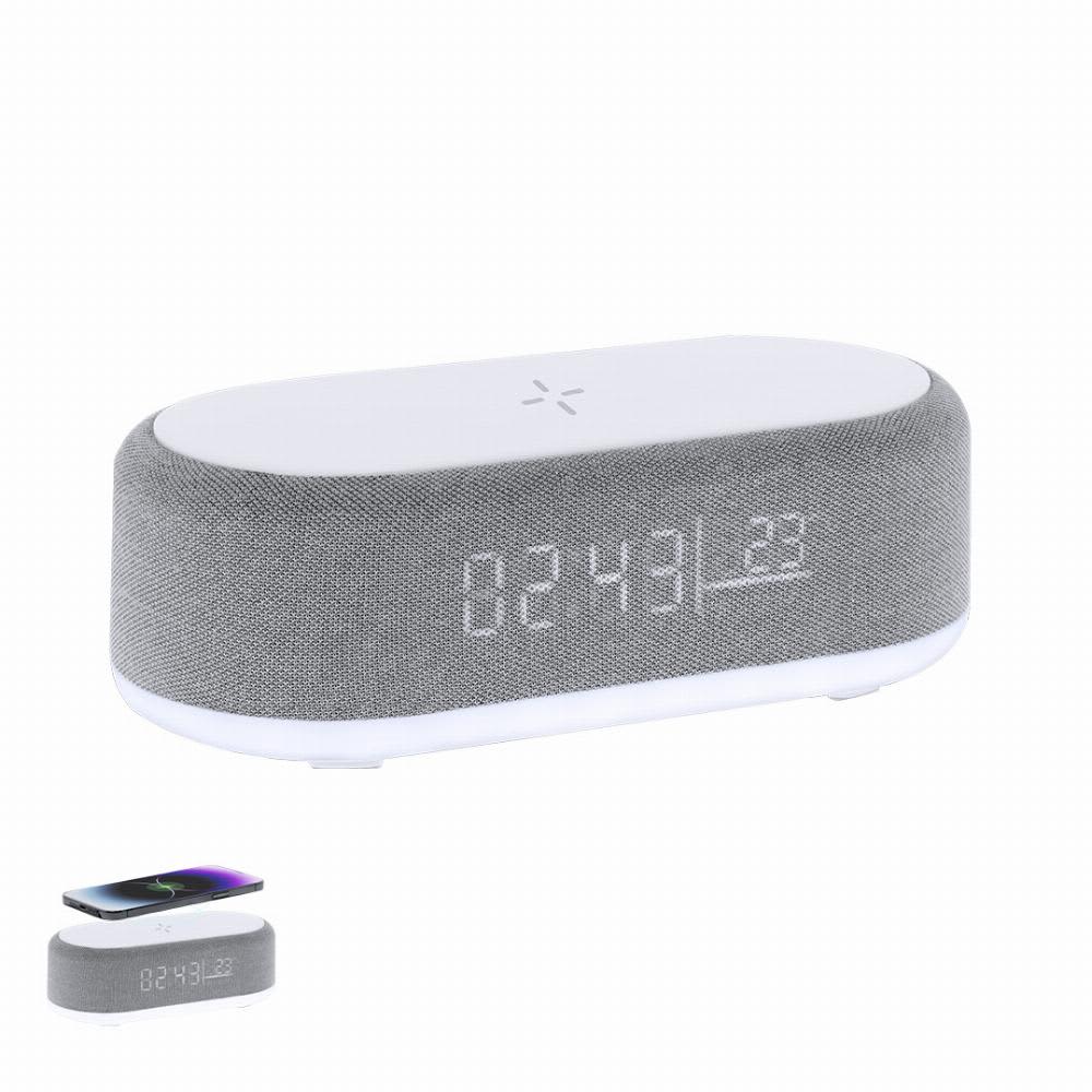 A grey and white wireless speaker with a digital clock display and a phone charging section on top. Quinn - Image 1
