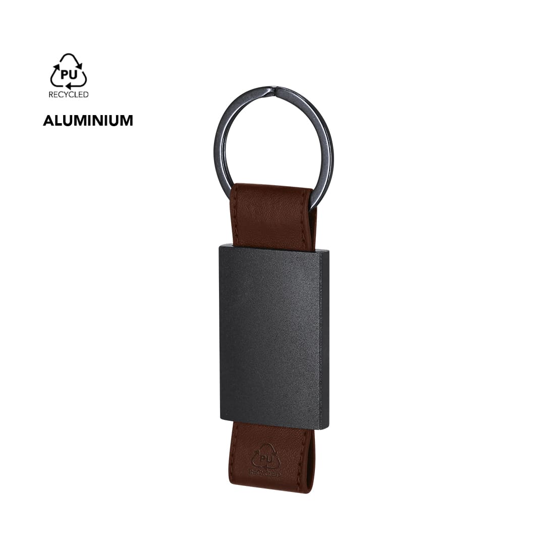 A black metal keyring with a brown PU leather strap, featuring a circular keyring and a branding logo. Versat Keyring - Image 1