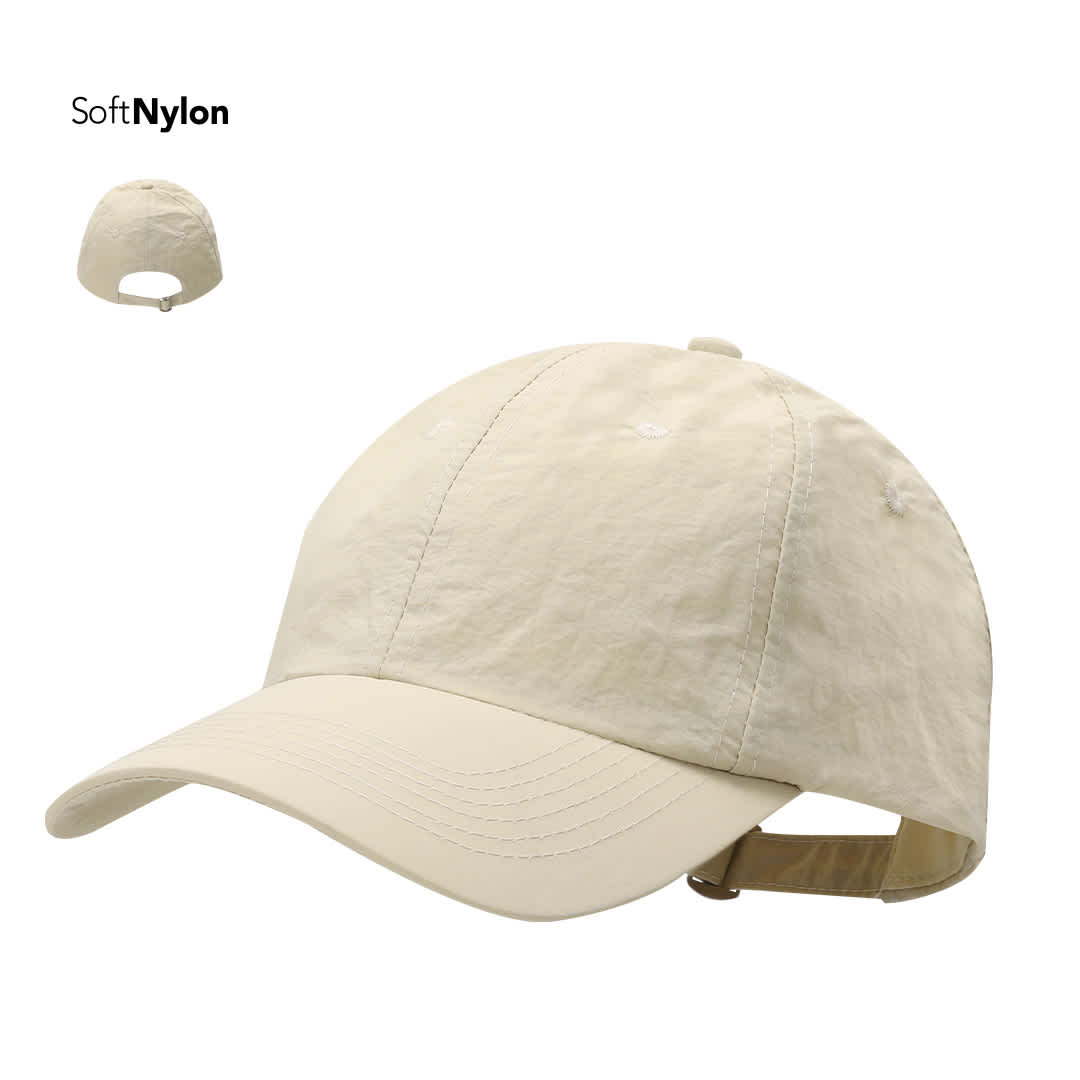 A beige cap made of soft nylon features a curved brim and an adjustable strap at the back. It has a logo. Mariner Cap - Image 1