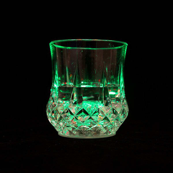 A glass wine glass with a clear base and green LED lighting, featuring a diamond pattern. LED Pineapple Inductive Wine Glass - Image 1