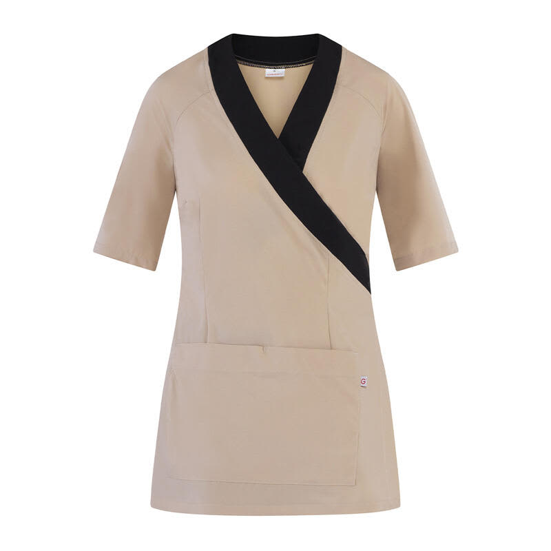 A beige tunic with short sleeves and a black wrap design, featuring a front pocket and a logo. Belen Tunic - Image 1