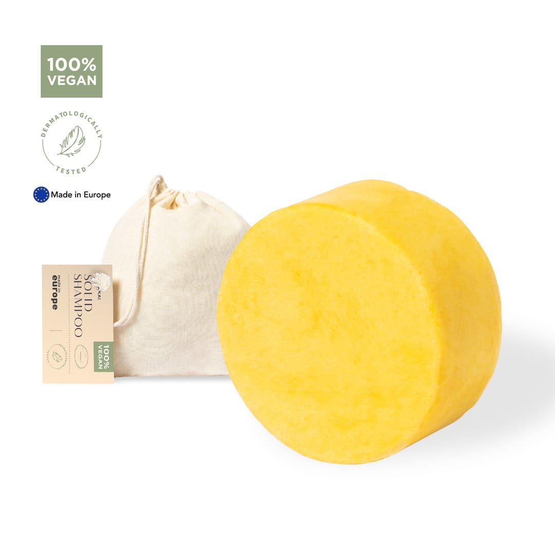 A round yellow shampoo bar with a small cotton bag, featuring a logo and labelled as vegan. Nanon Shampoo - Image 1