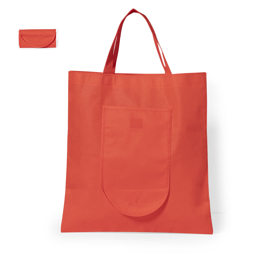 A foldable bag in bright orange with a front pocket and matching storage pouch, featuring a logo. Konsum Foldable Bag - Image 1