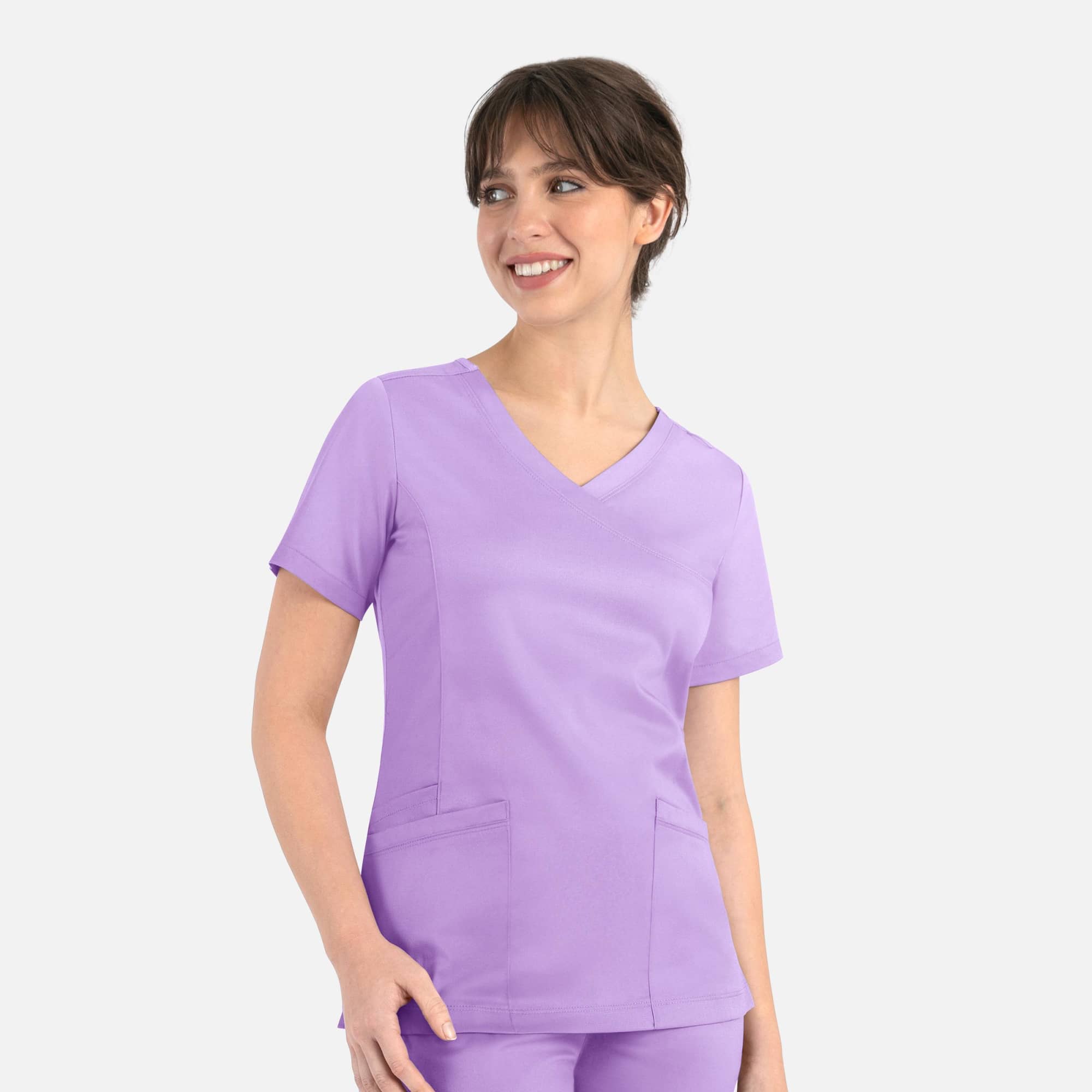 A purple women's curved mock wrap top featuring short sleeves and two front pockets, with a logo present. Matrix Womens Curved Mock Wrap Top - Image 1