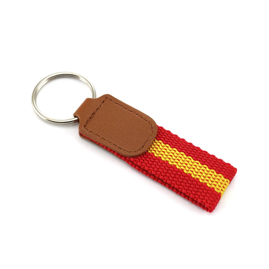 A red and yellow keyring with a leather tag and a metal ring for attachment. Espan Keyring - Image 1