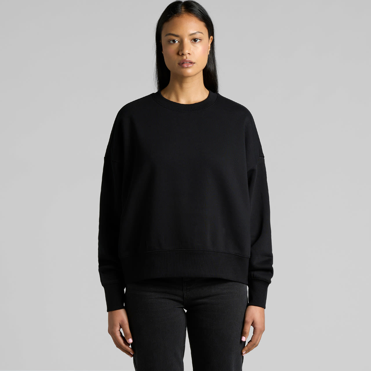 A black crew sweater with a relaxed fit and long sleeves, featuring a branding logo. Wo's Heavy Crew - Image 1