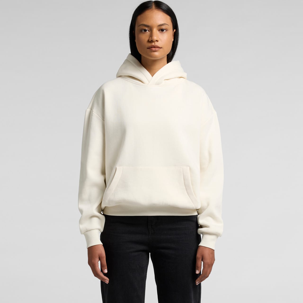 A cream-coloured hoodie with a kangaroo pocket and a hood, featuring a logo on the front. Wo's Box Hood - Image 1