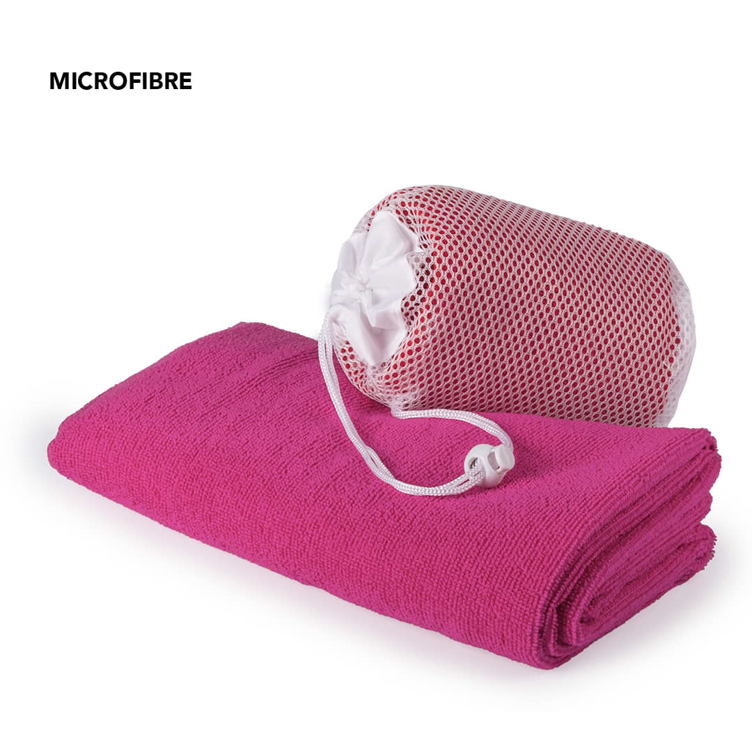 A pink microfibre towel folded beside a red and white mesh storage bag. The product has branding visible. Gymnasio Absorbent Towel - Image 1