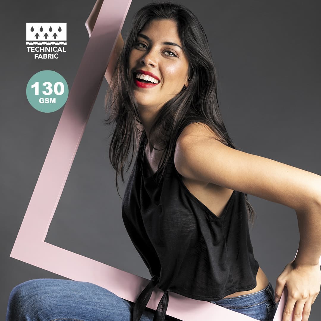 A black women's T-shirt made from technical fabric, featuring a model posing with a large pink frame. Slem Women T-Shirt - Image 1