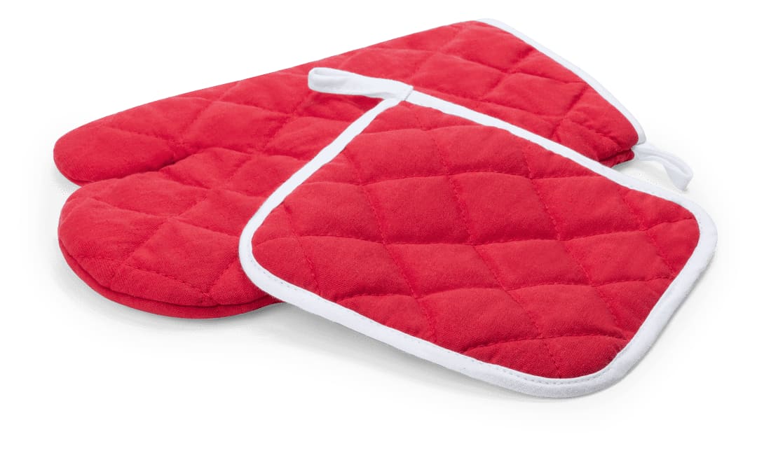 A red quilted oven mitt and pot holder set with white trim. The set includes one mitt and one flat holder. Leston Kitchen Set - Image 1