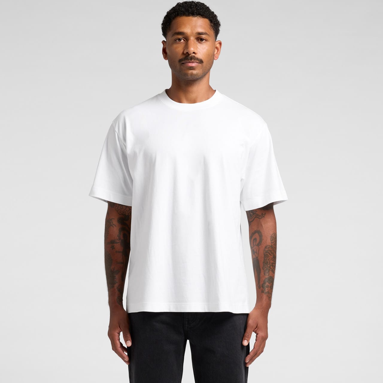 A plain white Box Tee t-shirt displayed on a model with short sleeves and a relaxed fit. Box Tee - Image 1