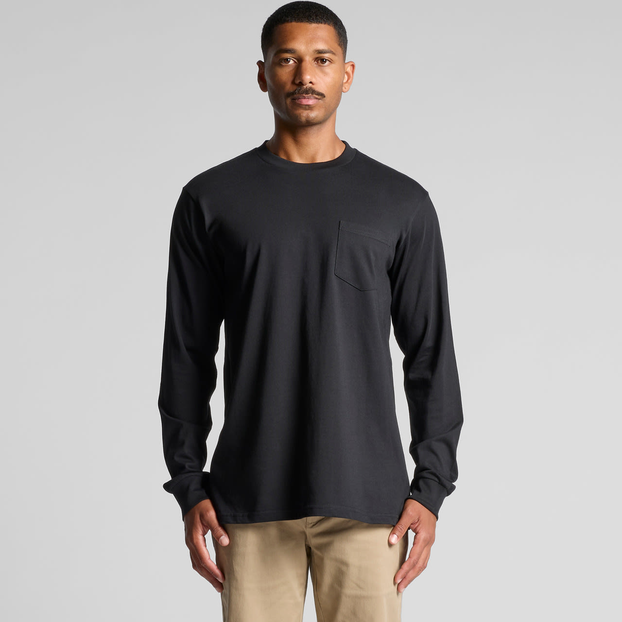 A long-sleeve, black pocket T-shirt featuring a simple design and a front pocket. Classic Pocket L/S Tee - Image 1