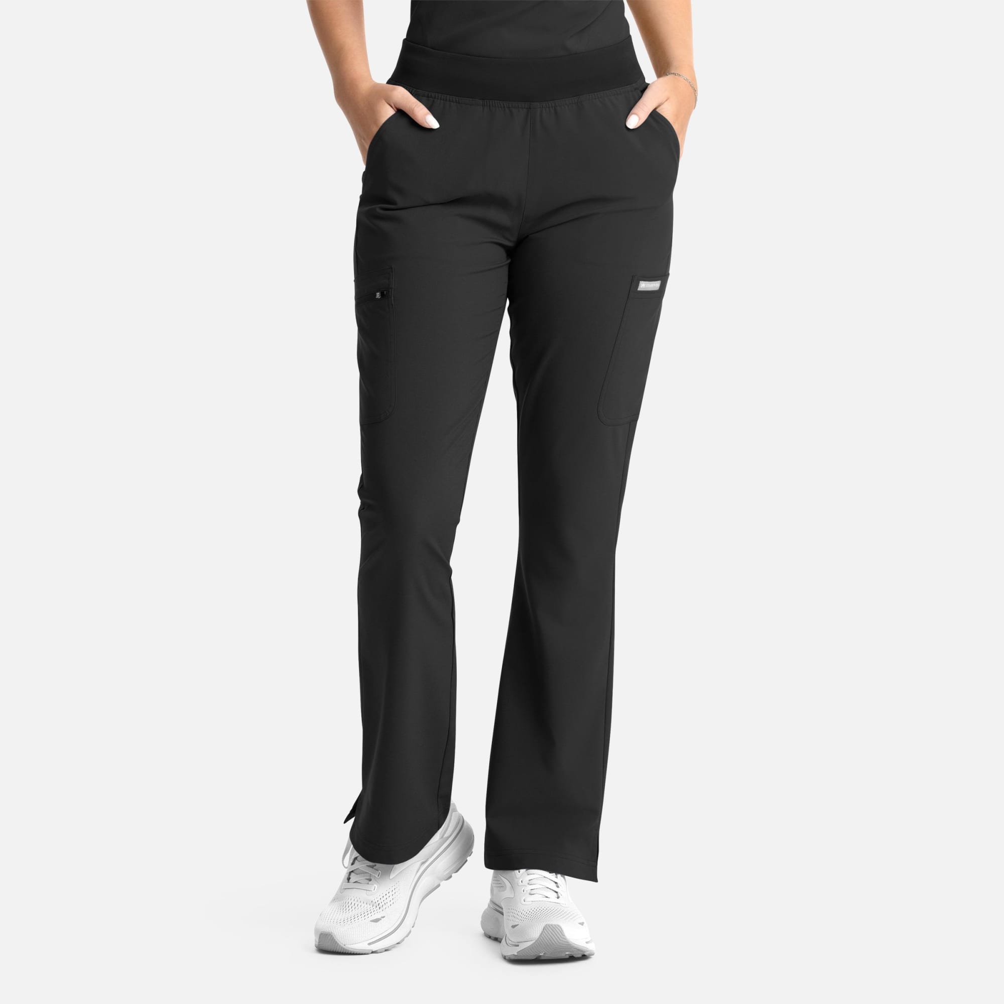 A pair of women's black flare leg pants with an elastic waistband, featuring pockets and a simple logo. Momentum Womens Full Elastic Band Flare Leg Pant - Image 1