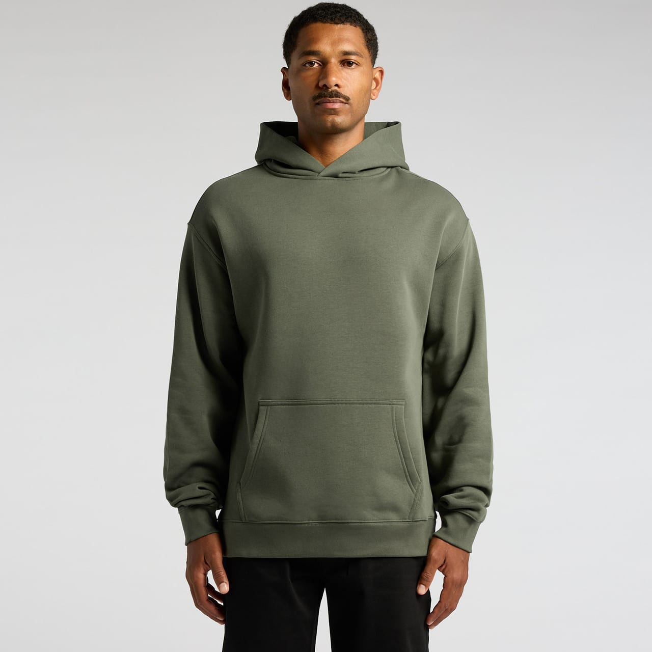 A green hoodie featuring a front pocket and a hood, worn by a model against a plain background. Relax Hood - Image 1