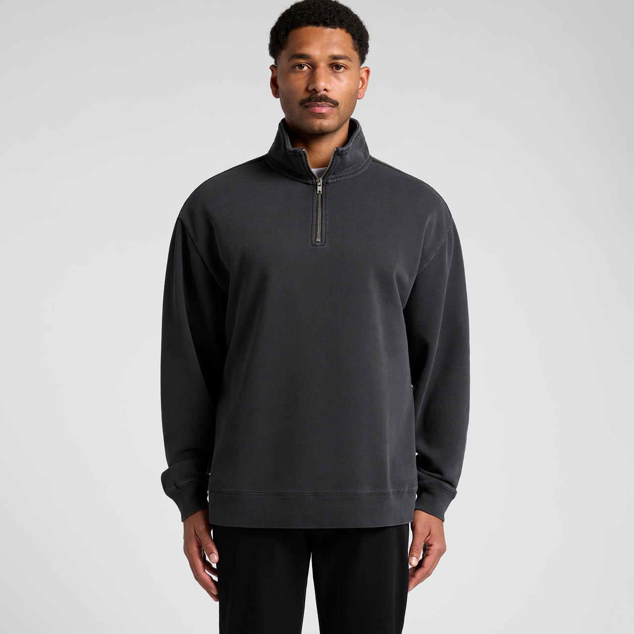 A black half-zip jacket with a relaxed fit and a small zippered collar. It features a logo on the chest. Relax Faded Half Zip - Image 1