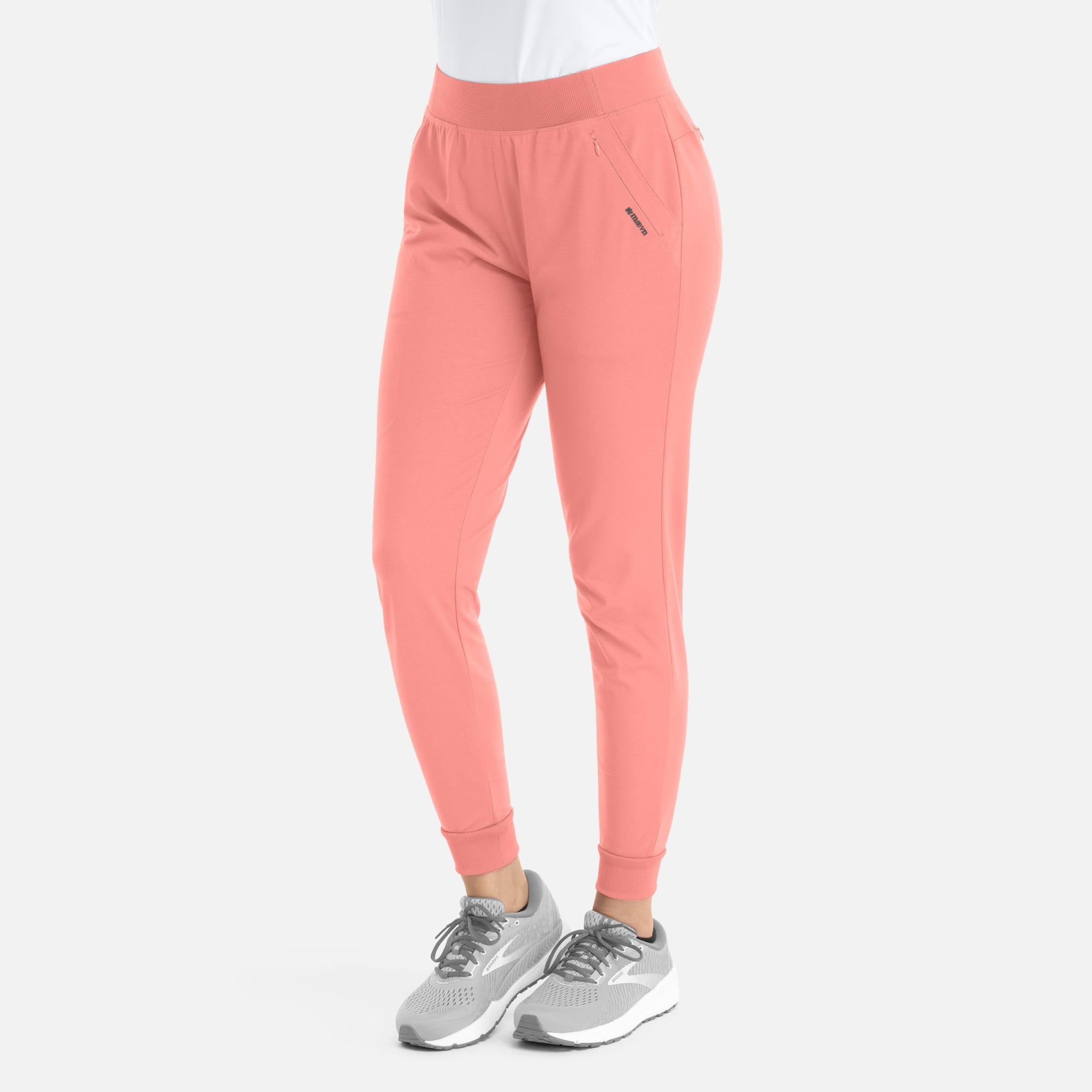 A pair of women's mid-rise joggers in a soft coral colour, featuring elastic waistband and cuffed ankles. Focus Womens Mid Rise Elastic Jogger - Image 1