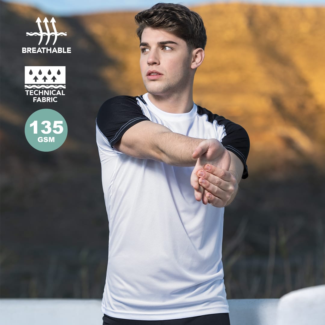 A white adult t-shirt with black sleeves, featuring a logo and made from breathable technical fabric. Tecnic Dinamic Comby Adult T-Shirt - Image 1