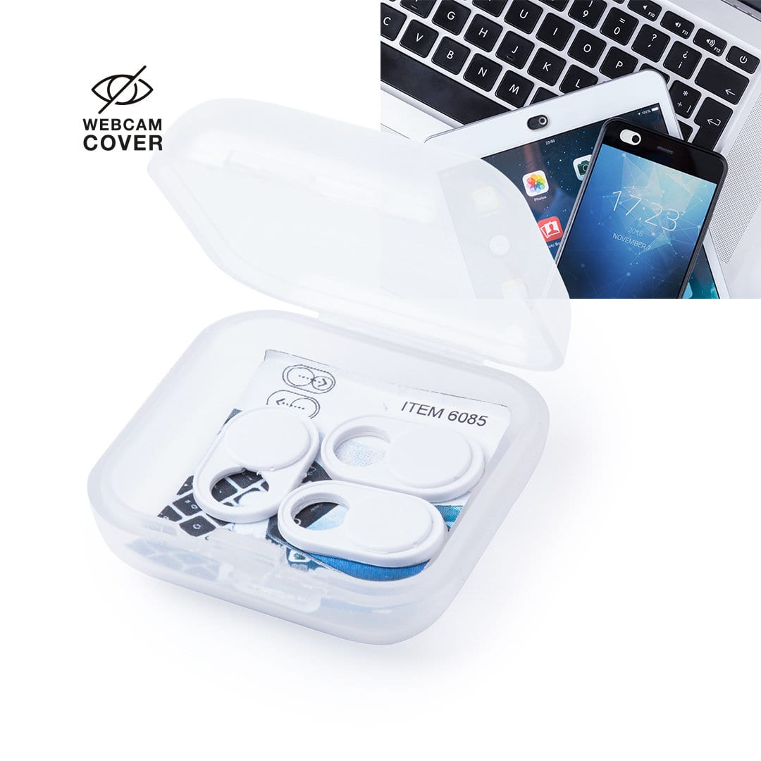 A transparent case containing multiple white webcam covers, alongside a smartphone and laptop. Pembol Webcam Cover - Image 1